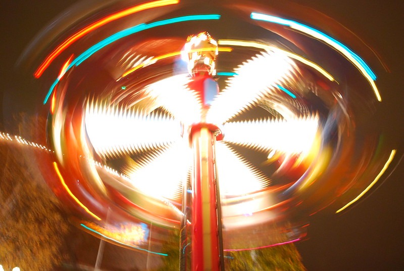 spinning carnival ride, with blurred lights and riders